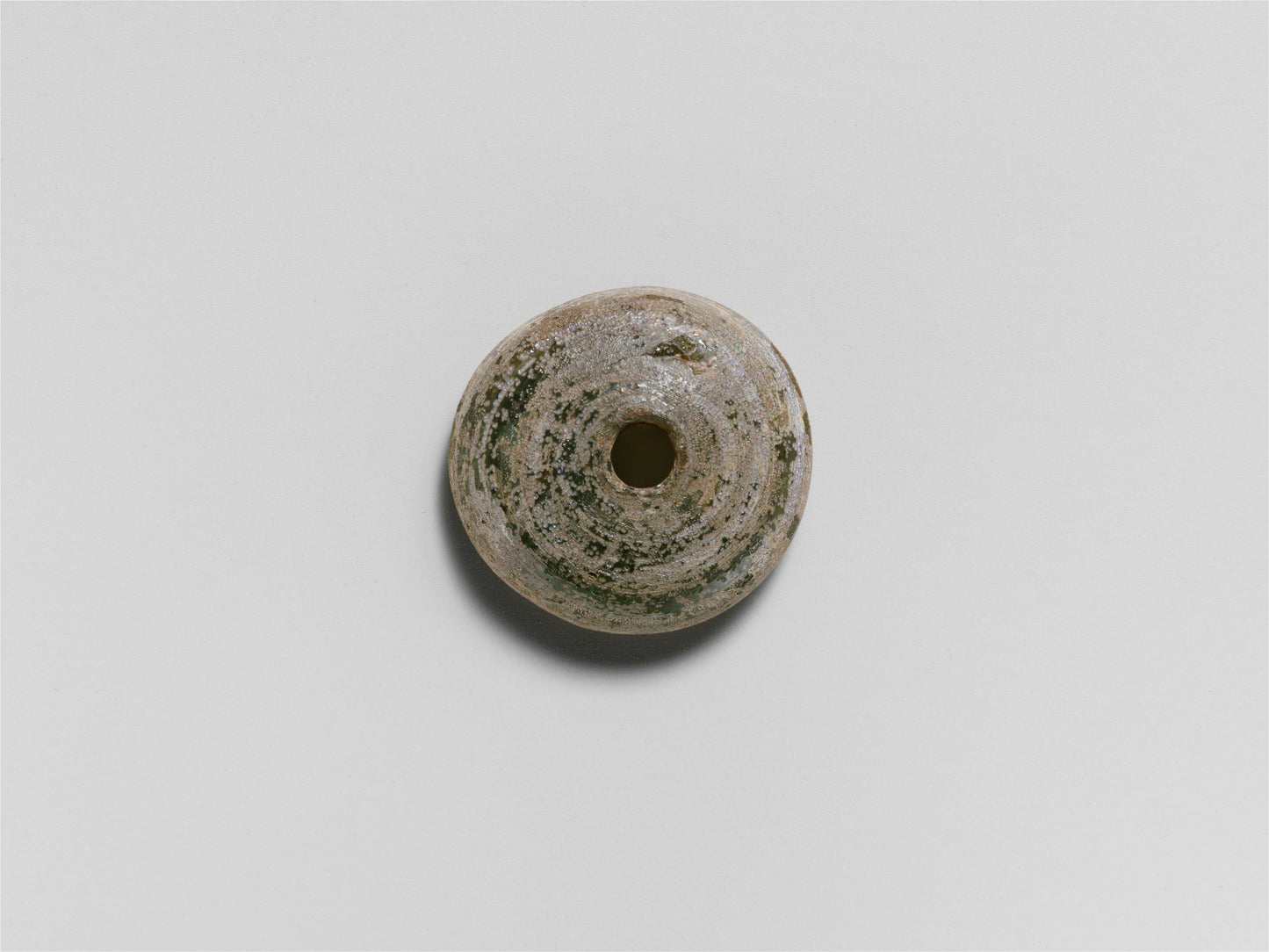 MUGG-078 — , Glass spindle whorl (ca. 1st–3rd century CE)